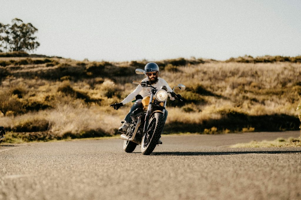 a man riding a motorcycle down a curvy road